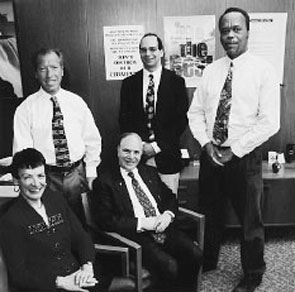 Assemblymember Colton is joined by Commission staff: Marilyn DuBois (seated), Richard Morse, Patrick Golden and Percival Miller (standing l-r).